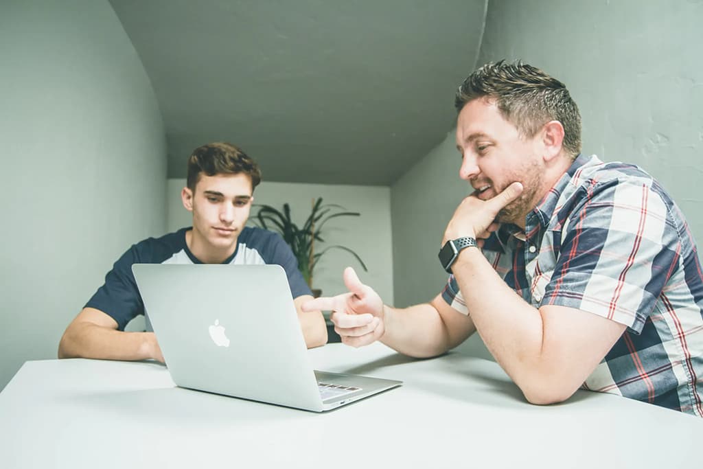 2 men meeting with a laptop